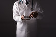 © kittipong - Professional doctor with stethoscope and smart phone gadget on hand. Medical and technology concept.Low light