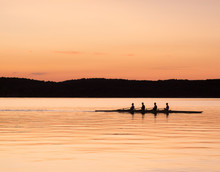 Rowing On The Sea At Sunset