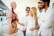 © NDABCREATIVITY - Students of medicine examining anatomical model in classroom