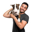 © Minerva Studio - Man holding his dog on a shoulder