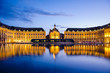 Reflection at blue hour of the Bourse Place with tramway in Bordeaux