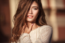 Close Up Portrait Of Young Beautiful Woman With Green Eyes And Long Healthy Hair In The Street. Hot Sunny Evening. Lifestyle Concept.