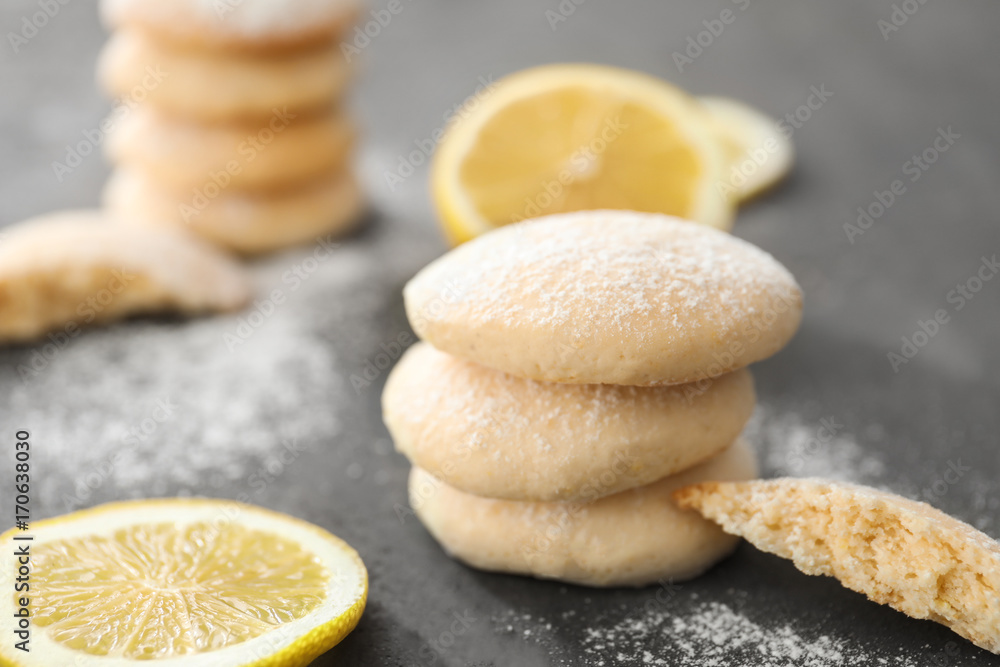 Homemade cookies with lemon flavor and sliced fruit on table