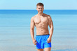 © Africa Studio - Handsome young man on sea beach