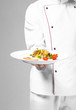 Chef presenting freshly cooked dish on light background, closeup