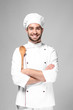 Young male chef on light background