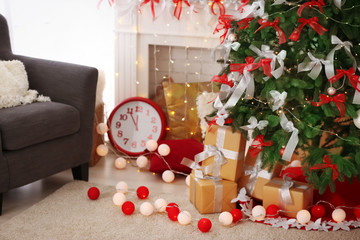 Canvas Print - Gift boxes under beautiful fir tree decorated for Christmas in living room