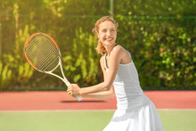 Young Woman Playing Tennis On Court