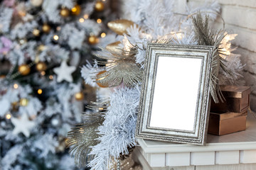 Wall Mural - Empty blank photo frame in christmas decorated defocused background with toys lights