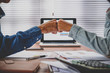 © Satori Studio - Business team giving fist bump after complete deal.