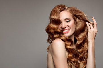 Portrait of woman with long curly beautiful ginger hair.