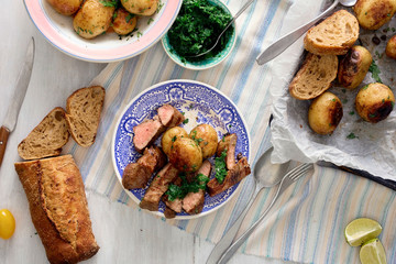 Poster - Slices of beef steak with baked potatoes on plate