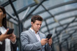© ReeldealHD images - Businessman listening to podcast waiting for train at station