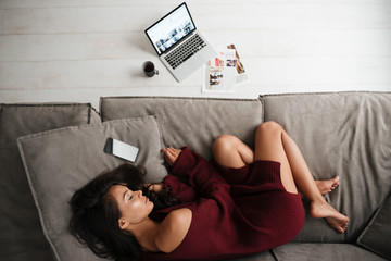 Poster - Top view of a beautiful asian woman in sweater sleeping