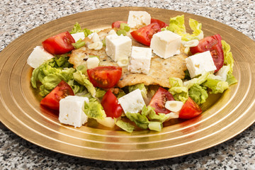 Wall Mural - potato pancake, mediterranean style with tomato, salad and goat cheese