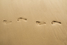 Footprints On Beach.