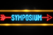 Symposium  - fluorescent Neon Sign on brickwall Front view