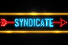 Syndicate  - Fluorescent Neon Sign On Brickwall Front View