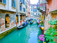 Classical Picture Of The Venetian Canals With Boats Across Canal