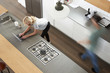 © Monkey Business - Overhead View Of Busy Couple In Modern Kitchen