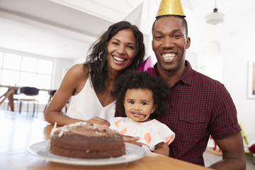 Wall Mural - Parents Celebrating Birthday With Young Daughter At Home