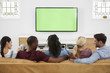 © Monkey Business - Rear View Of Group Of Young Friends Watching Television Together