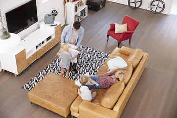 Wall Mural - Overhead Shot Of Parents Playing With Children In Lounge