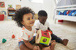 © Monkey Business - Baby Boy And Girl Playing With Toys In Playroom Together