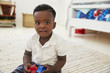 © Monkey Business - Portrait Of Happy Boy Playing With Toys In Playroom