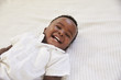 © Monkey Business - Overhead Shot Of Smiling Young Boy Lying On Bed