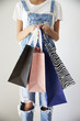 © Monkey Business - Close Up Of Woman Standing At Home Holding Shopping Bags