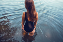 Beautiful sexy woman in black swimsuit at the sea, beautiful tan, sexy mood, amazing slim woman in sexy swimwear