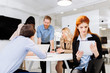 © NDABCREATIVITY - Business colleagues sitting at desk