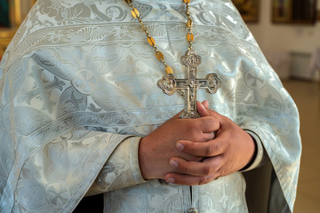 Orthodox christian priest holds cross