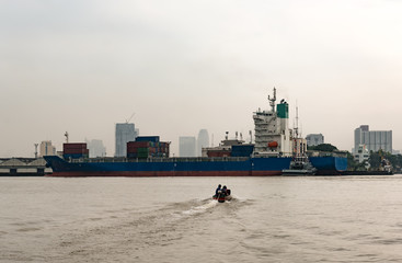 Logistics and transportation of International Container Cargo ship in a harbor for logistic import export background and transport industry with Drizzling rain and haze day.