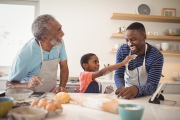 Multi-generation family with flour on the nose standing in the