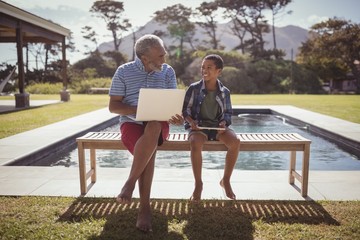 Wall Mural - Grandfather and grandson interacting with each other near