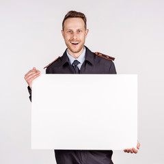 Canvas Print - russian officer policeman showing presentation, pointing on paper placard.