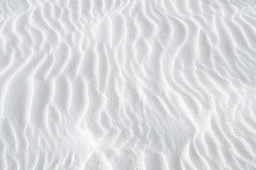 white sand texture background with wave pattern and insect trails