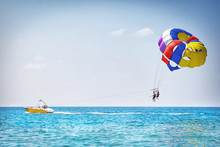 Parachuting In Turkey. Parasailing With Boat Over Sea In Alanya In Beautiful Summer Day. Tropical Beach Vacation.