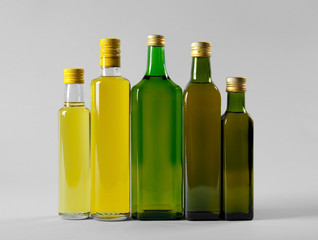 Wall Mural - Bottles of cooking oil on light background