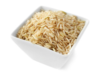 Canvas Print - Bowl of long grain brown rice on white background