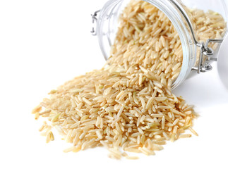 Canvas Print - Long grain brown rice and glass jar on white background