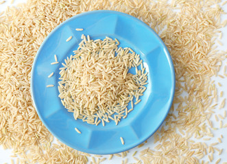 Canvas Print - Plate of long grain brown rice on white background