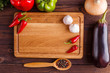 Food background with chopping board in spices and vegetables framing. top view, copy space. Cooking ingredients on wooden table