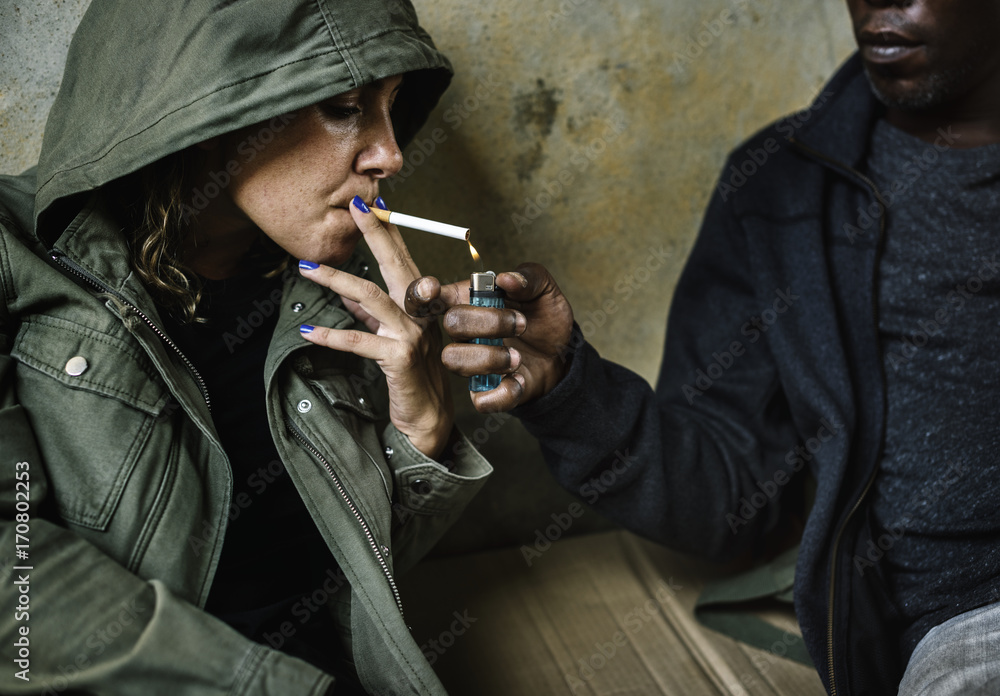 Homeless sharing a cigarette to others Stock Photo