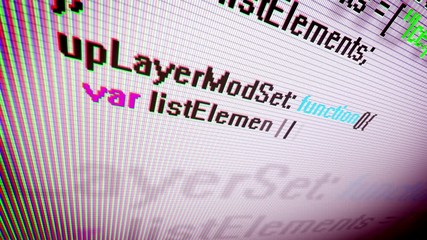 Wall Mural - closeup of the coding information process on a pc screen shown askew with swiftly rushing multicolor