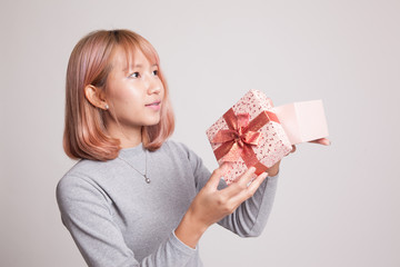 Young Asian woman open a gift box.