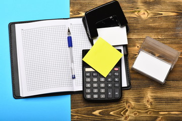 Stationery and open leather covered notebook as business concept