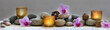 concept of wellbeing with pebbles, orchids and candles, panoramic